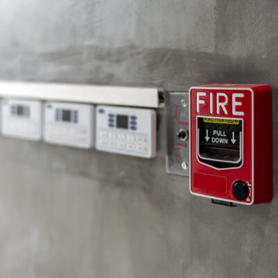 closeup red fire alarm box with soft-focus and over light in the background