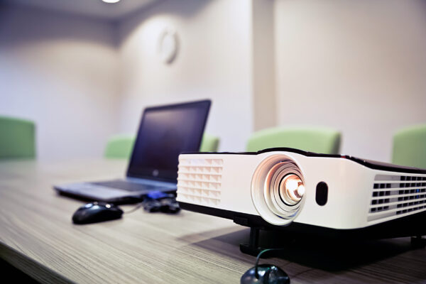 Projector and laptop on the table.